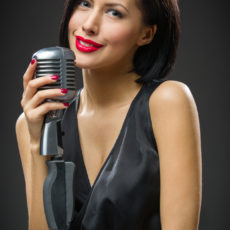 Female singer handing microphone